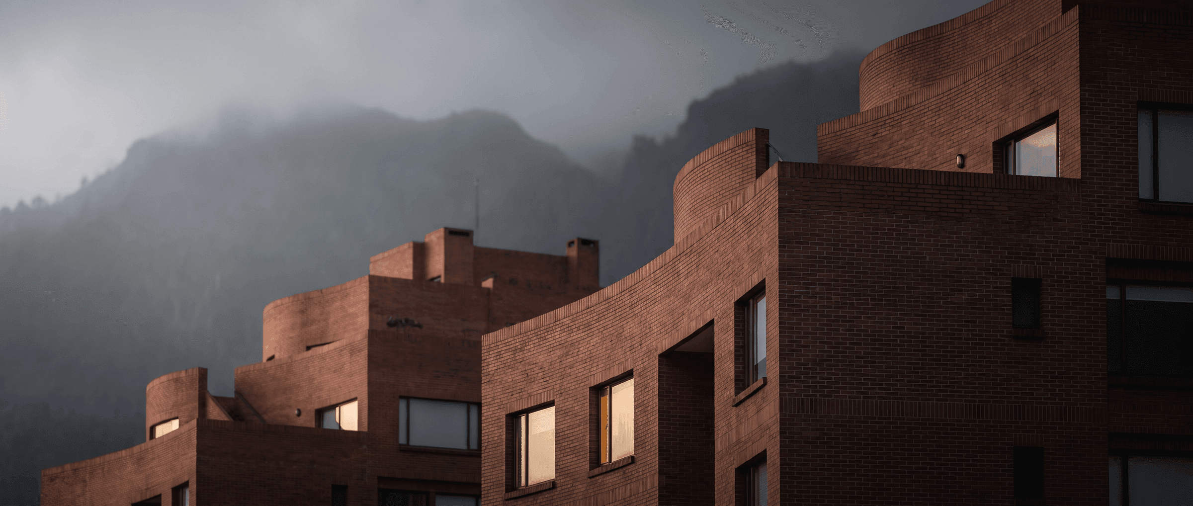 Bogotá brick buildings with the mountains in the mist.